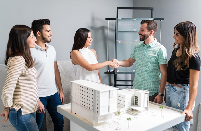 business-partners-shaking-hands-with-engineer-by-architectural-model-meeting_662251-1666 1