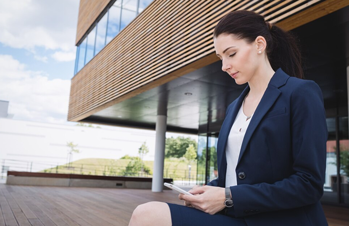 businesswoman-using-mobile-phone_107420-84724 1